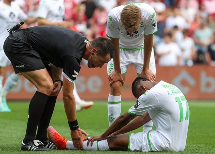 Ghanaian midfielder Abu Francis receiving medical treatment after injury