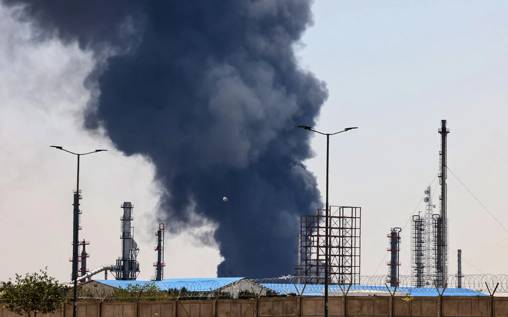 A plume of heavy smoke and fire rise over an oil refinery in southern Tehran Iran, after it was hit in an overnight Israeli strike,
